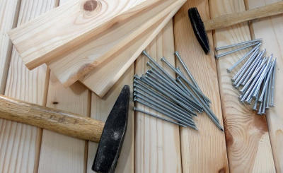 hammer and nails laying on wood