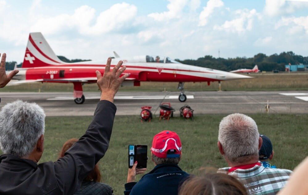 man waving at goodbye jet plane taking off