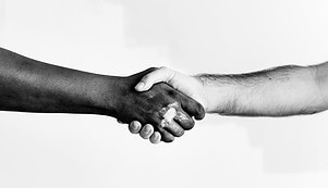 black and white men shaking hands